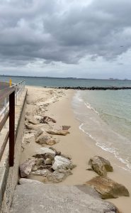 Dolls point sea water touching the land across the coastal walking path on a gloomy day!