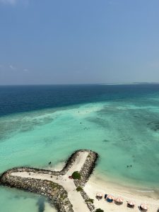 A man-made pathway near the sea shore making a "Y" form near the white sand!