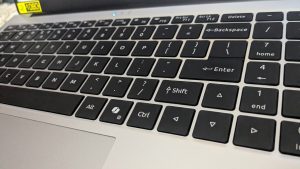 A picture focused on a keyboard showing all the alphabet, digits, and numbers.
