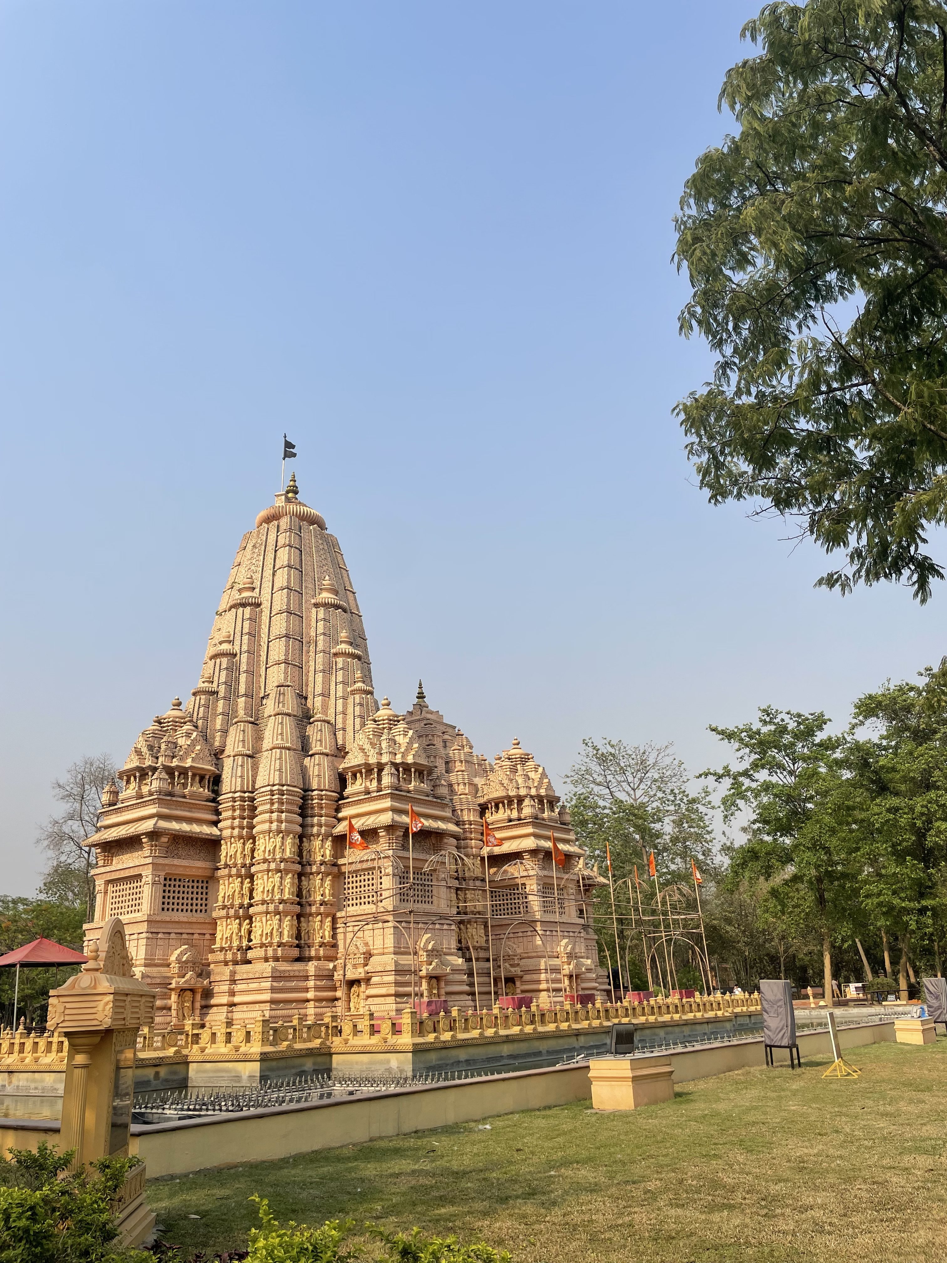 A grand, detailed CG temple stands majestically under a clear blue sky.
