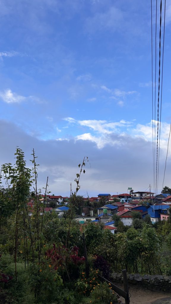 A scenic view of a colorful hillside neighborhood under a partly cloudy sky.