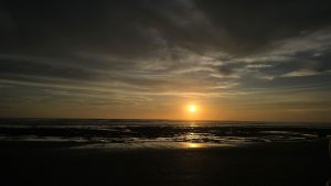 A beautiful sunset view with a dark cloudy sky at the Masachapa beach, Nicaragua.