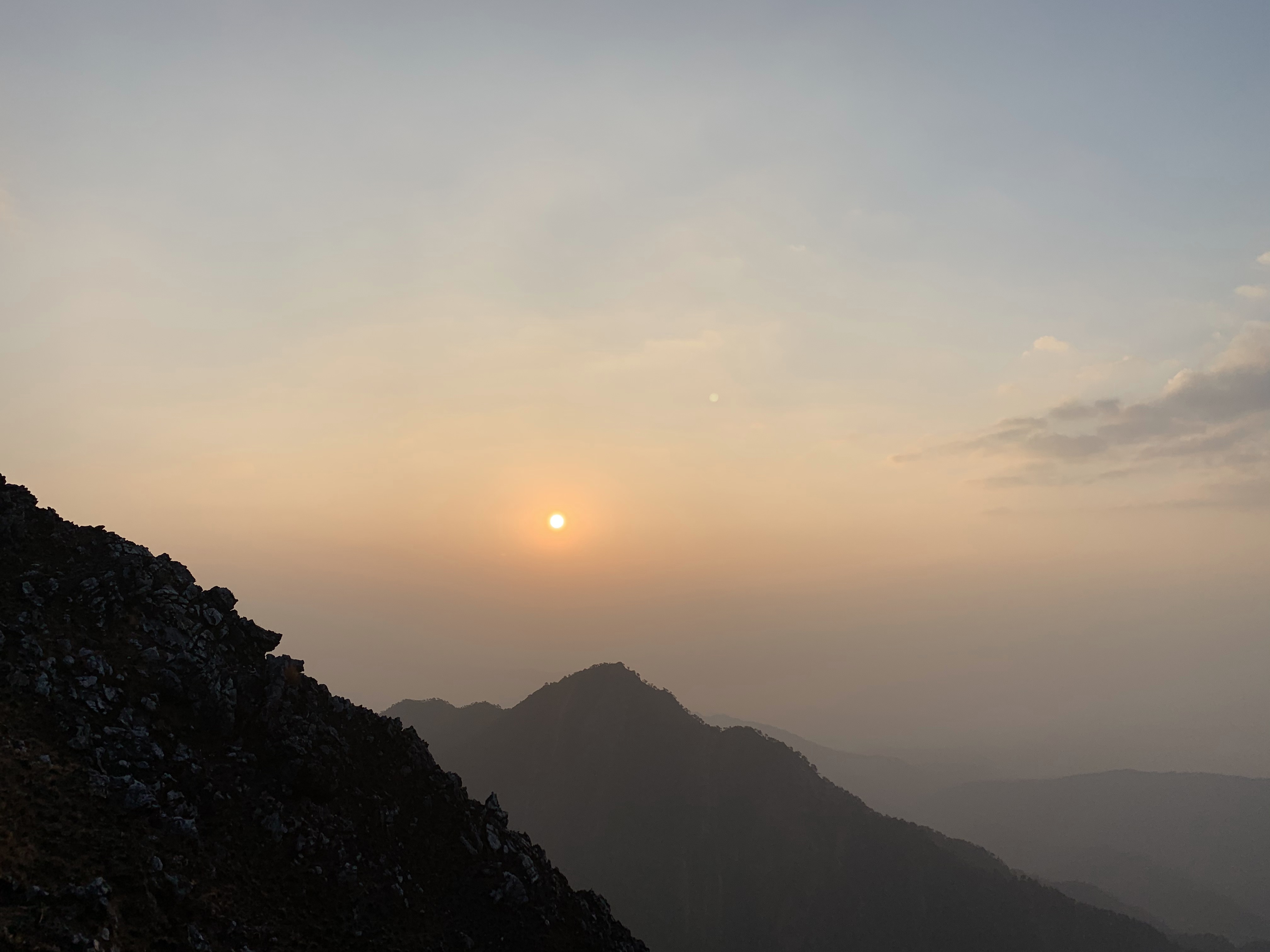 Orange sunrise over hazy mountains in Devchuli, Nawalparasi.