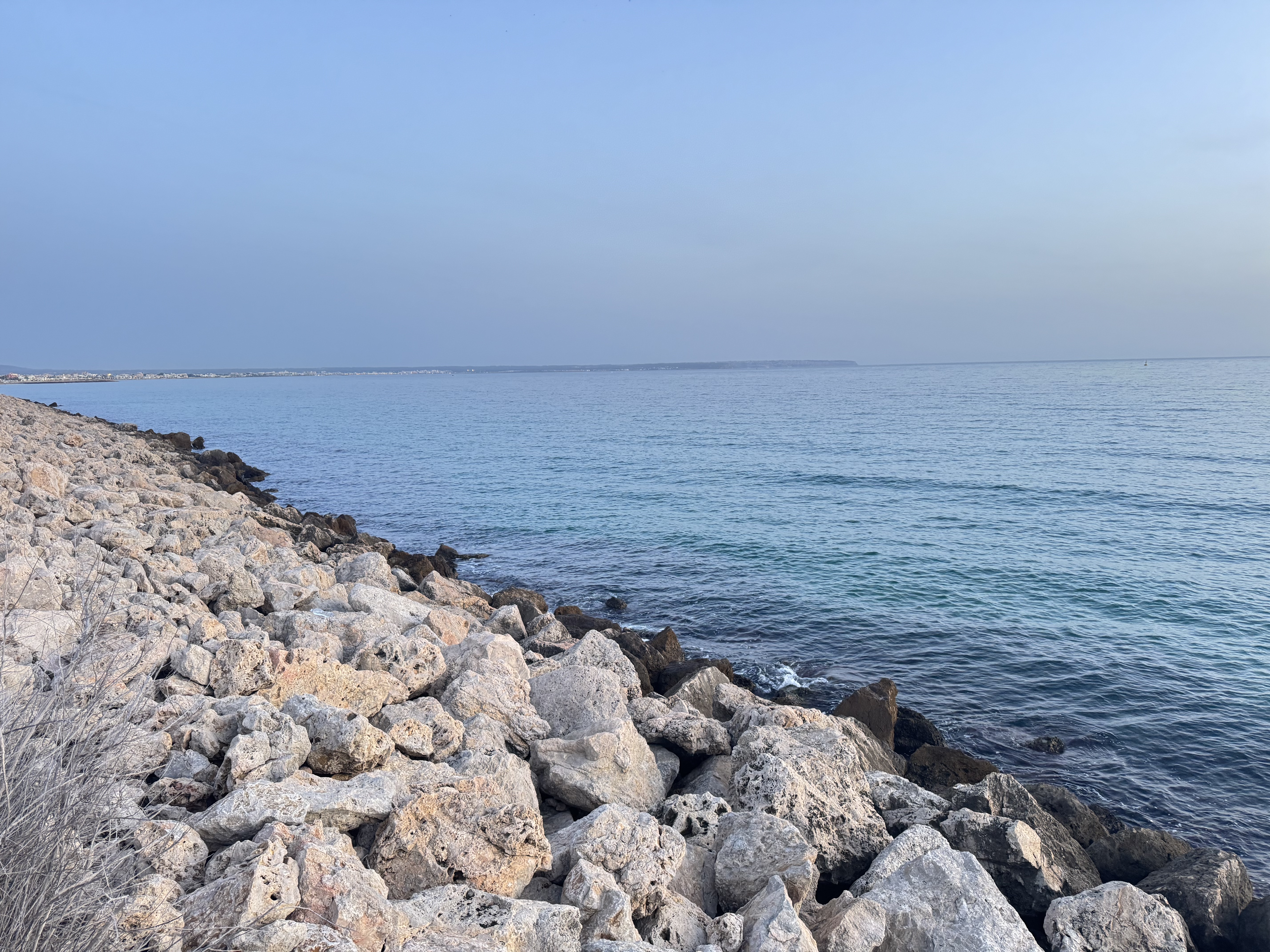 The rocky shoreline with clear blue sky near Palma de Mallorca.
