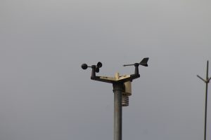 A wind vane and windsock installed on top of the building.
