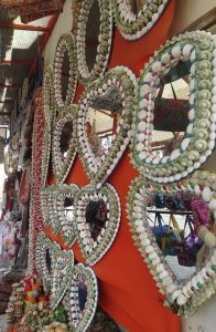 Different seashell decorated mirrors.
