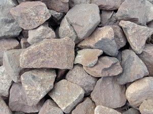 A pile of irregular shaped gray rocks, up close.