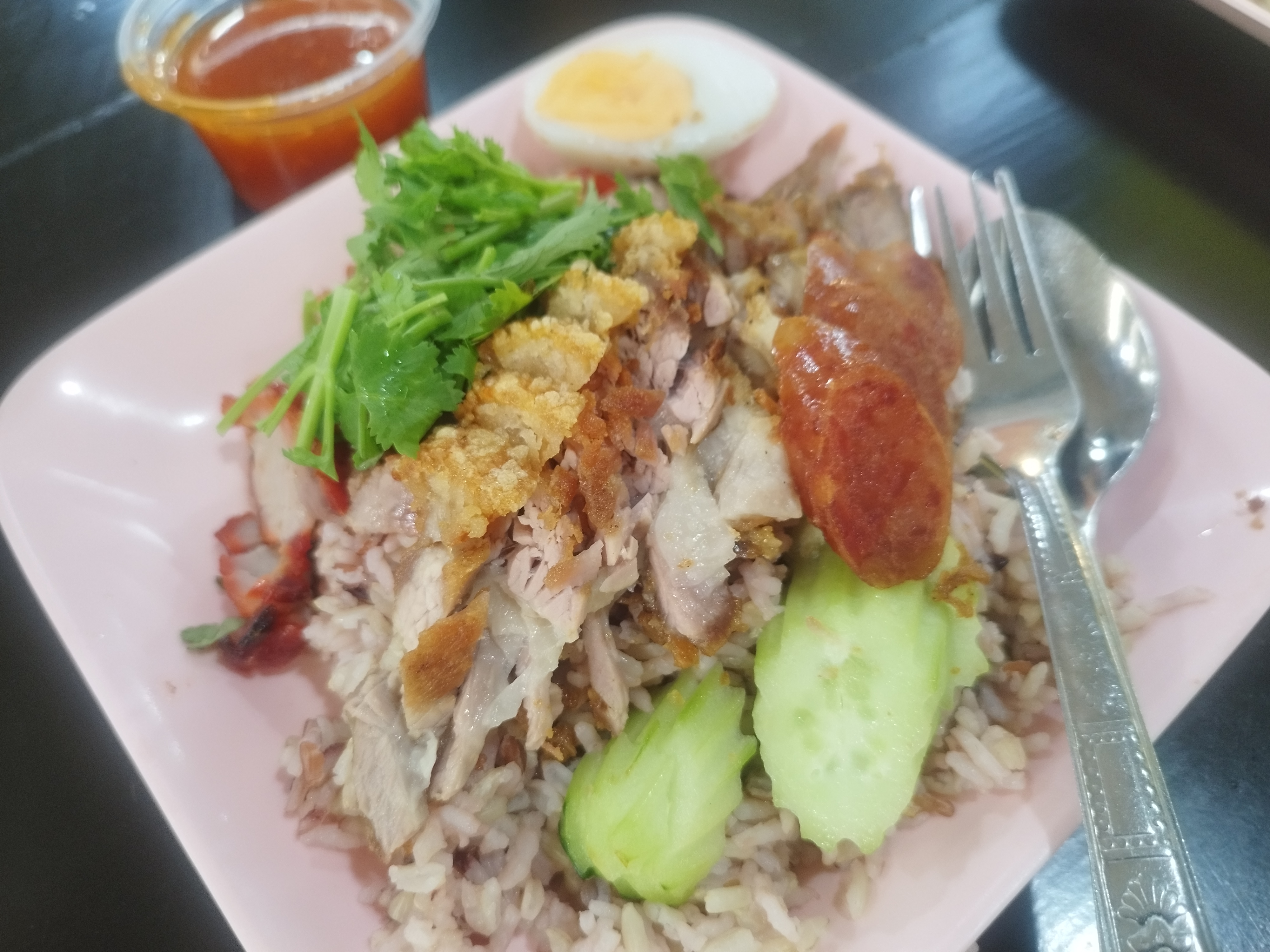 Khao Moo Daeang Moo Grob. crispy pork and barbecue pork with rice. Chinese style dish. Quick meal dish. Popular Thai dish. Rice with pork and gravy.