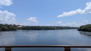 A beautiful calm river showing beach area at the old Jinja bridge 
