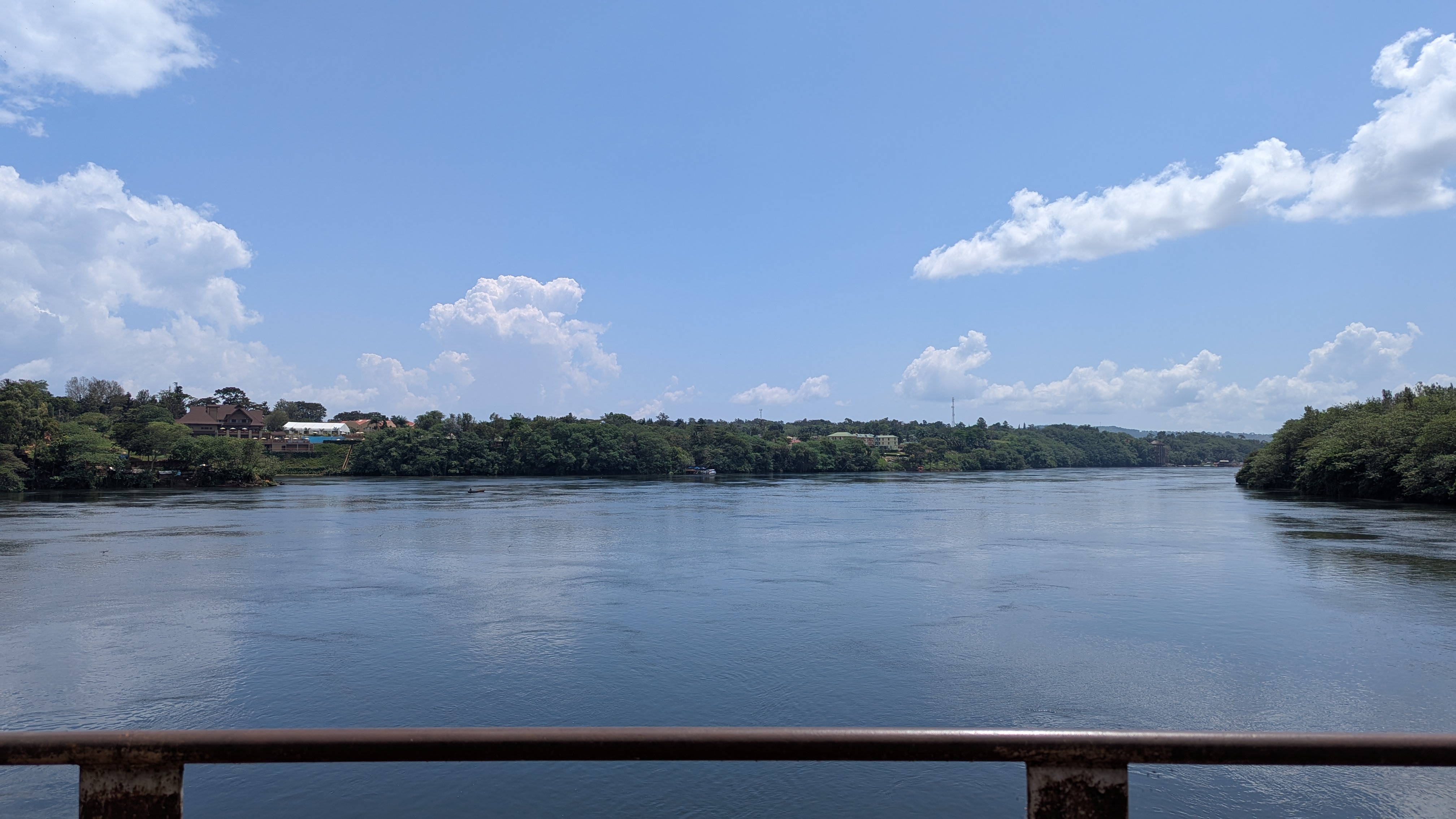 A beautiful calm river showing beach area at the old Jinja bridge 