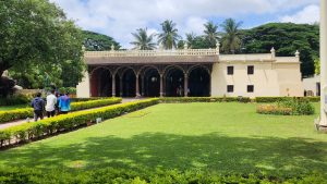 A single story building behind a green front yard.