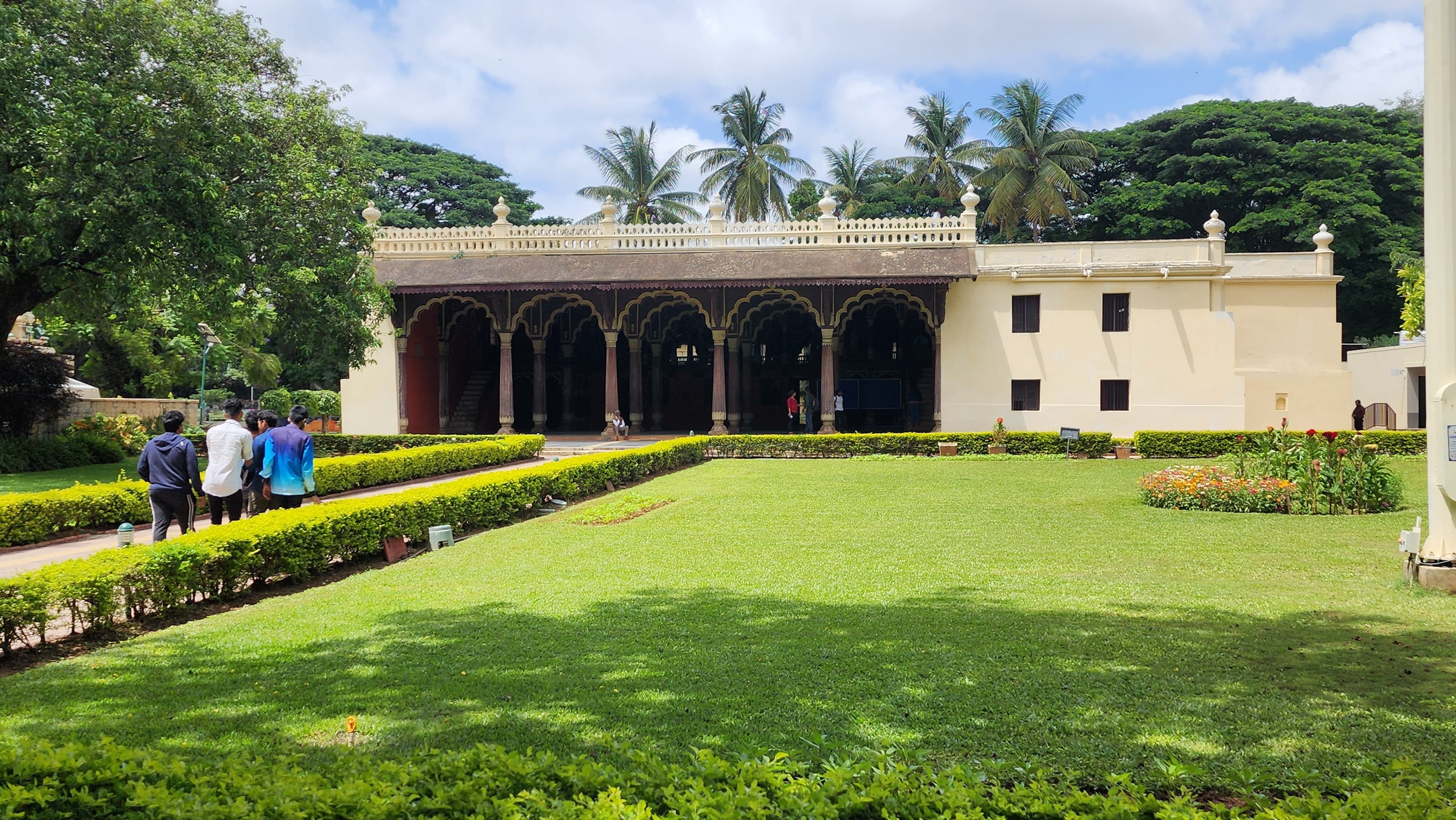A single story building behind a green front yard.