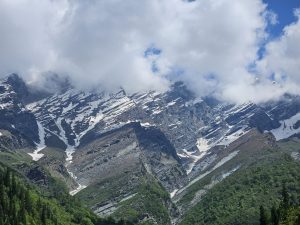 Mountain whispers in the shadow of clouds with snow slop.