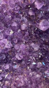 Closeup of purple crystals from the inside of a geode.
