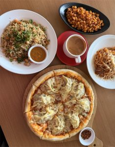 A wooden table featuring a variety of dishes.