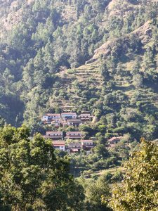 A scenic view of a hillside village surrounded by lush greenery. 