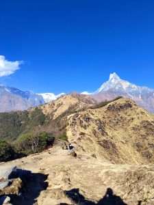 
A panoramic view of a mountainous landscape featuring a clear blue sky
