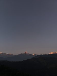 A scenic view of majestic mountains under a twilight sky.