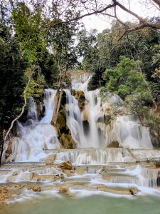 Kuang Si Waterfalls near Luang Prabang, Laos, cascade gracefully over limestone terraces into turquoise pools, surrounded by dense tropical forest, creating one of the country’s most scenic natural landmarks and a serene jungle retreat.