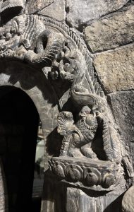 A close-up of a stone wall featuring intricate carvings. 