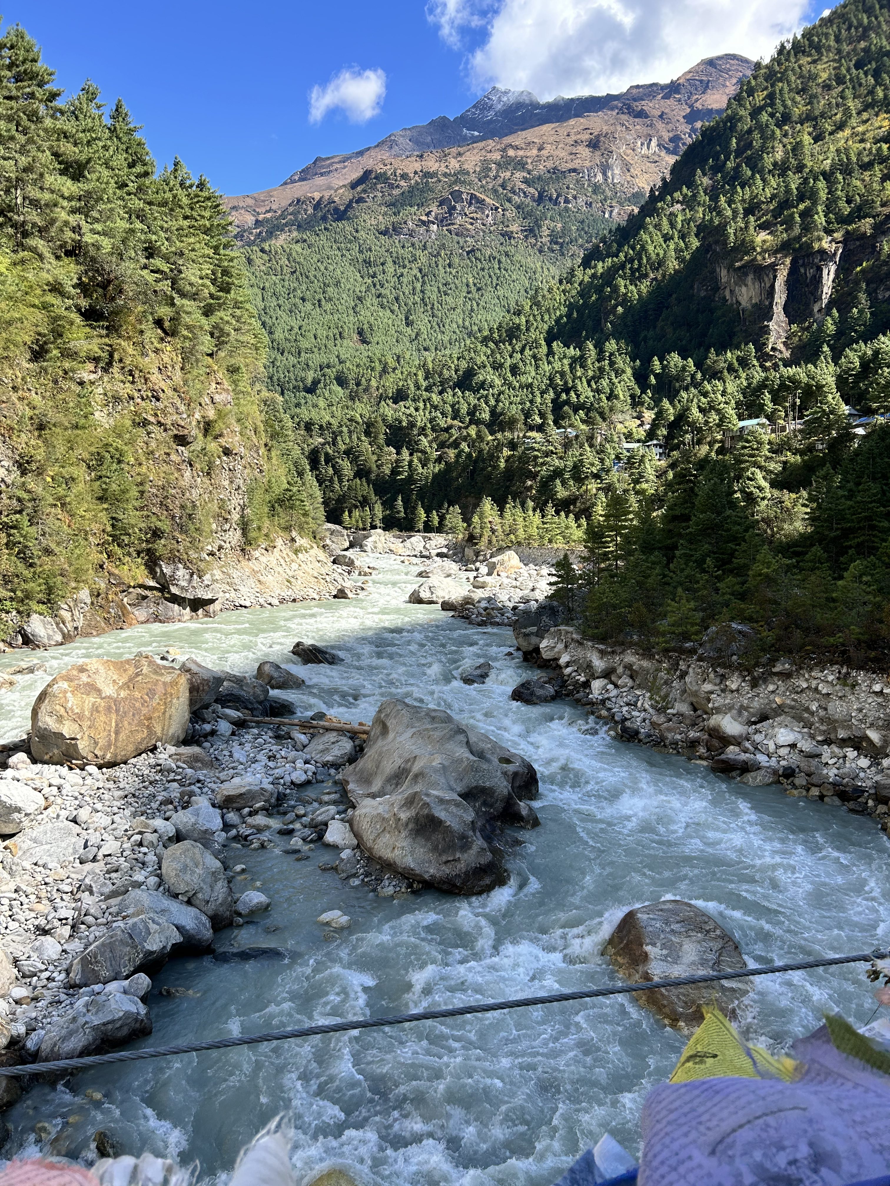 A picturesque landscape featuring a winding river surrounded by rocky banks. 