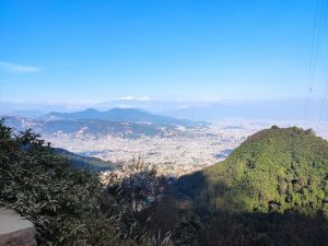 A panoramic view of the city from Chandragiri Mountain under a clear blue sky.