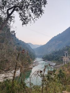 A serene landscape featuring a river winding through a mountainous valley.