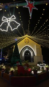 
A beautifully decorated church at night, featuring an array of festive lights