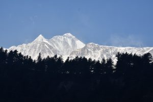 Snow-capped mountains under a clear blue sky in Mustang.