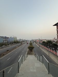
A wide view of a quiet urban road taken from an elevated position. 