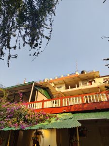 
A low-angle view of a colorful building complex against a clear blue sky.