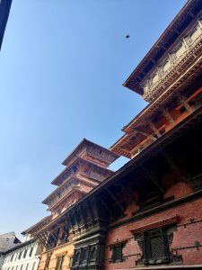 A stunning view of intricately designed, multi-tiered traditional architecture against a clear blue sky.