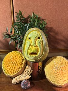 A beautifully arranged display featuring intricately carved fruits and vegetables.