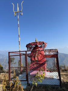 A Hindu shrine dedicated to Goddess Pathibhara, adorned with red cloths and a sacred trident (Trishul).