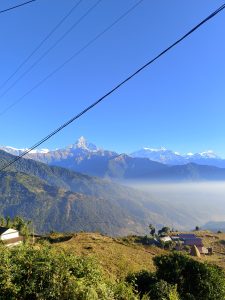 A wide view of a mountainous landscape under a clear blue sky.
