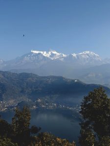 A panoramic view of majestic snow-capped mountains under a clear blue sky.
