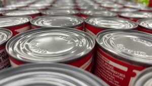 Closeup of the lids of soup cans, all pressed together into a grid.

