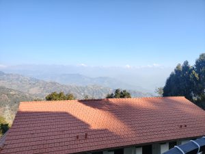 A panoramic view of a mountain landscape under a clear blue sky
