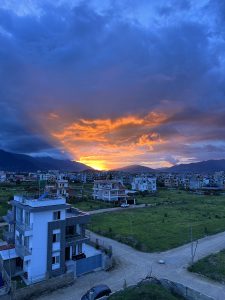 Golden Hour Sunset in the open clear field with houses 