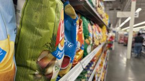 A row of potato chip bags, with the closest on the left blurring away to the right.