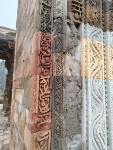 
A close-up view of a stone wall featuring intricate carvings and patterns