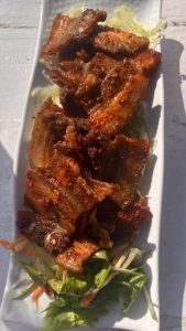 Pork sekuwa with grilled meat and fresh vegetables.