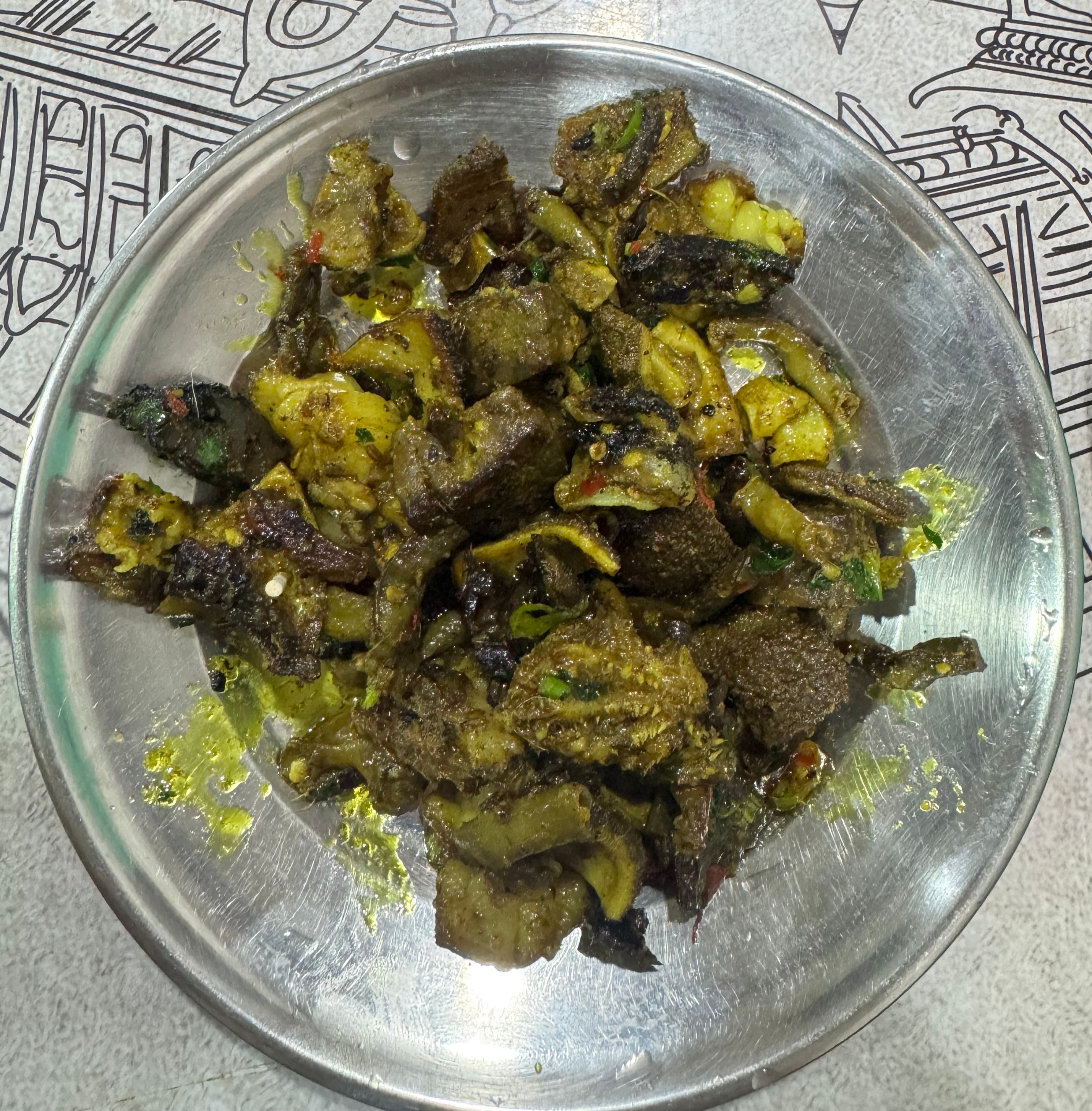 A round stainless steel bowl filled with a mix of cooked ingredients