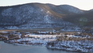 The sun setting on a snowy Iona Island in the Hudson River with Jones Point in the background.