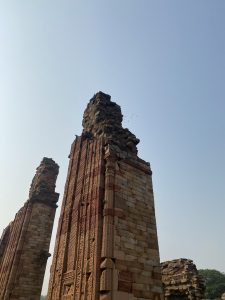 A tall stone ruin with intricate carvings and decorative patterns.