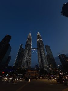 Petronas Twin Tower

A nighttime view of the Petronas Twin Towers, two tall skyscrapers known for their twin structures, illuminated against a dark blue sky. The buildings are connected by a skybridge at the mid-level. 