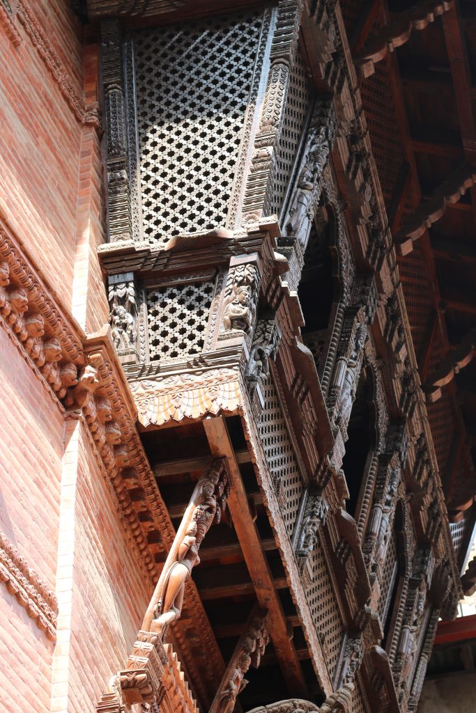 The structures feature Durbar Square, located in Kathmandu, Nepal, with detailed wood carvings, including traditional carved windows.