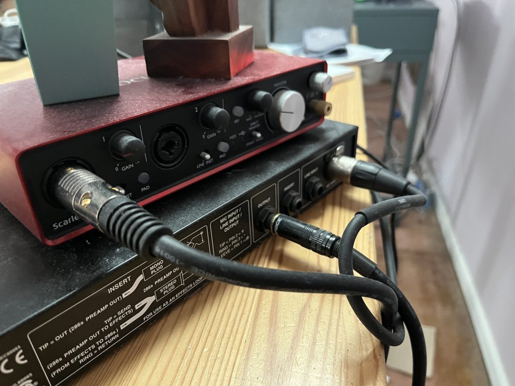 Closeup of wires plugged into audio equipment.