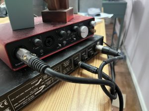 Closeup of wires plugged into audio equipment.