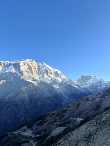 
A breathtaking landscape featuring towering snow-capped mountains under a clear blue sky.